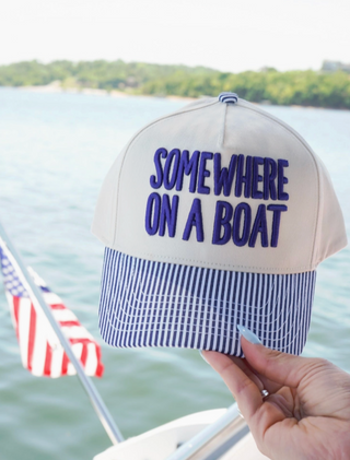 somewhere on a boat trucker hat
