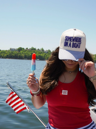 somewhere on a boat trucker hat